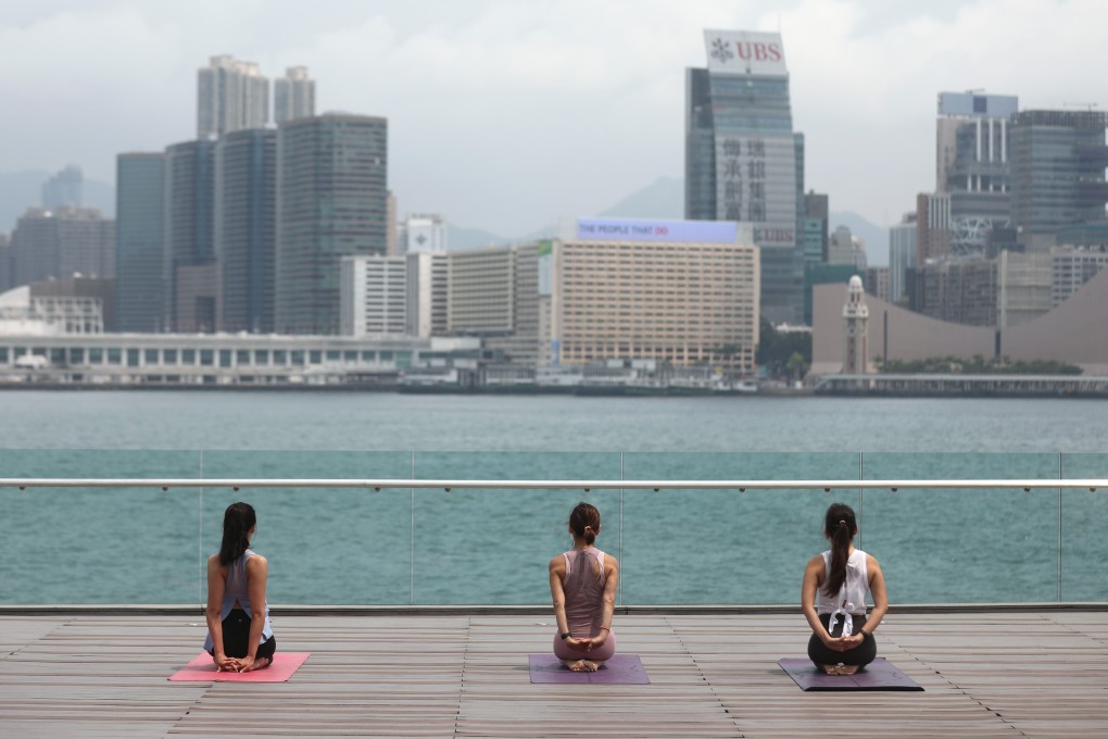 Women practise yoga at Tamar Park in Central on April 21. As the number of new Covid-19 cases in the city drops, Hongkongers are venturing out more. Photo: Winson Wong
