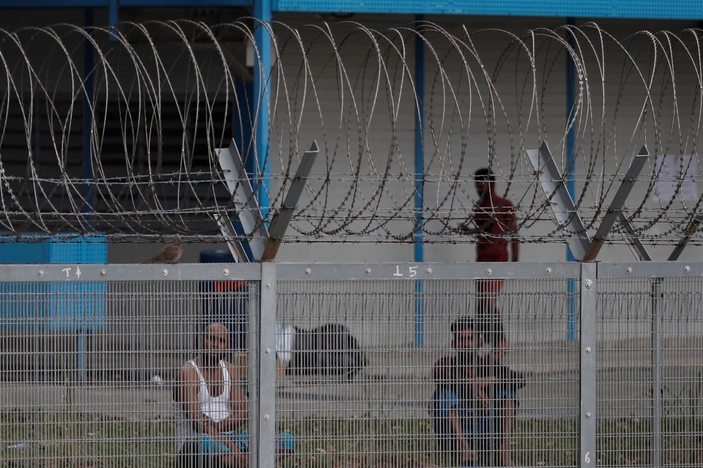 Migrant workers sit outside their rooms at Punggol S11 dormitory, during the coronavirus outbreak in Singapore. Photo: Reuters