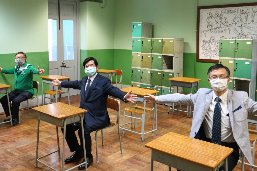 School officials at St Joseph's College demonstrate the distancing measures taken with desks that will be used by DSE exam takers. Photo: Handout