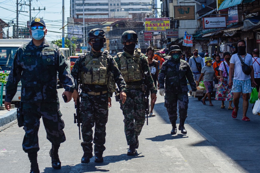 Policemen patrol on patrol during lockdown in Manila. Photo: AFP
