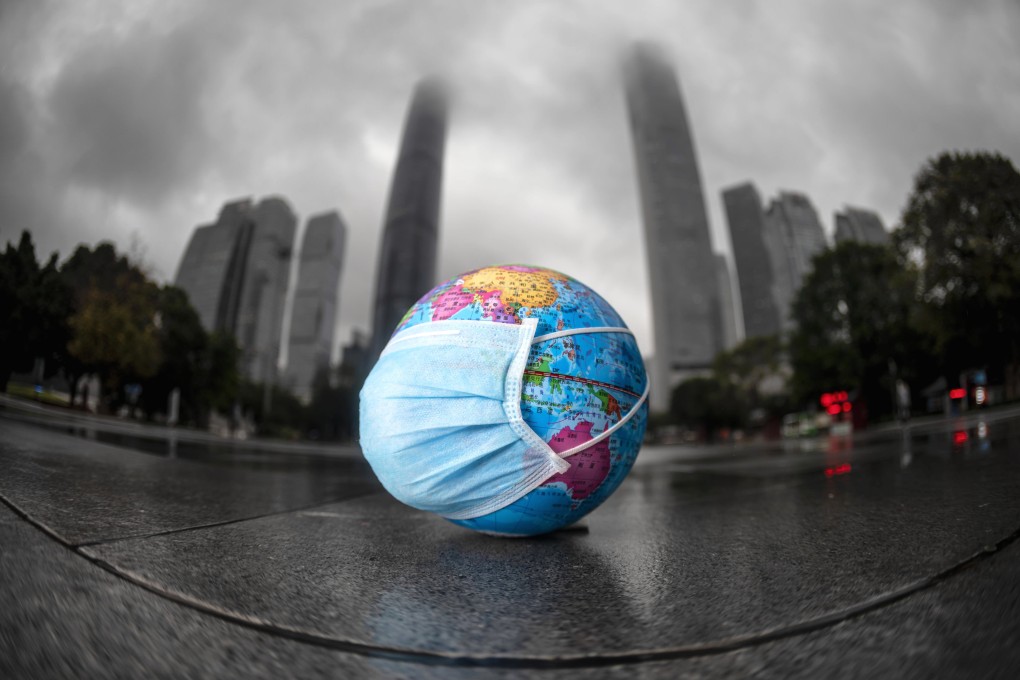 A model of the globe wearing a face mask is left on the ground by the children playing with it in Guangzhou city of China on April 22, when many countries marked World Earth Day to raise awareness of environmental protection. Photo: EPA-EFE