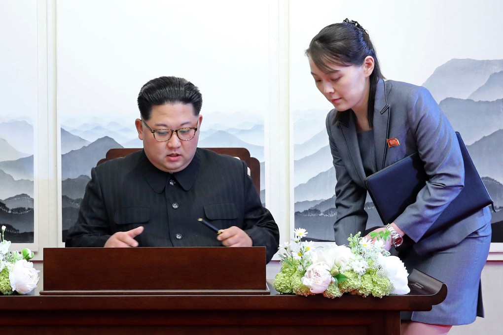 North Korean leader Kim Jong-un signs a guestbook next to his sister Kim Yo-jong inside the Peace House at the demilitarised zone in April 2018. Photo: Korea Summit Press Pool via AP