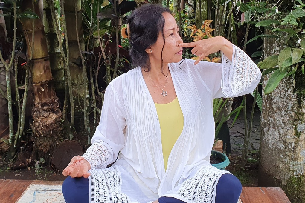 Sutha Atiin practising a meditative breathing technique. She, like many others during the coronavirus pandemic, is turning to meditation to stay calm and focused. Photo: Angela Jelita