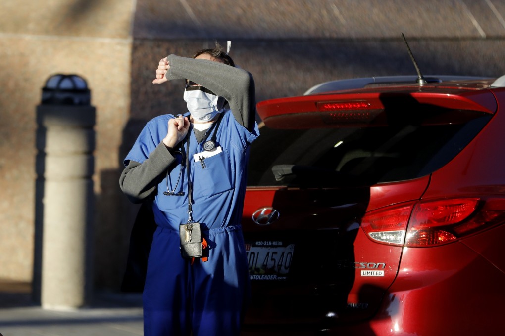 A US health worker covers his eyes from the sunlight while leaving the Baltimore VA Medical Centre. Photo: AP