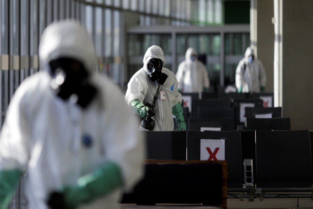 Brazilian soldiers disinfect the airport in Rio de Janeiro. Photo: Reuters