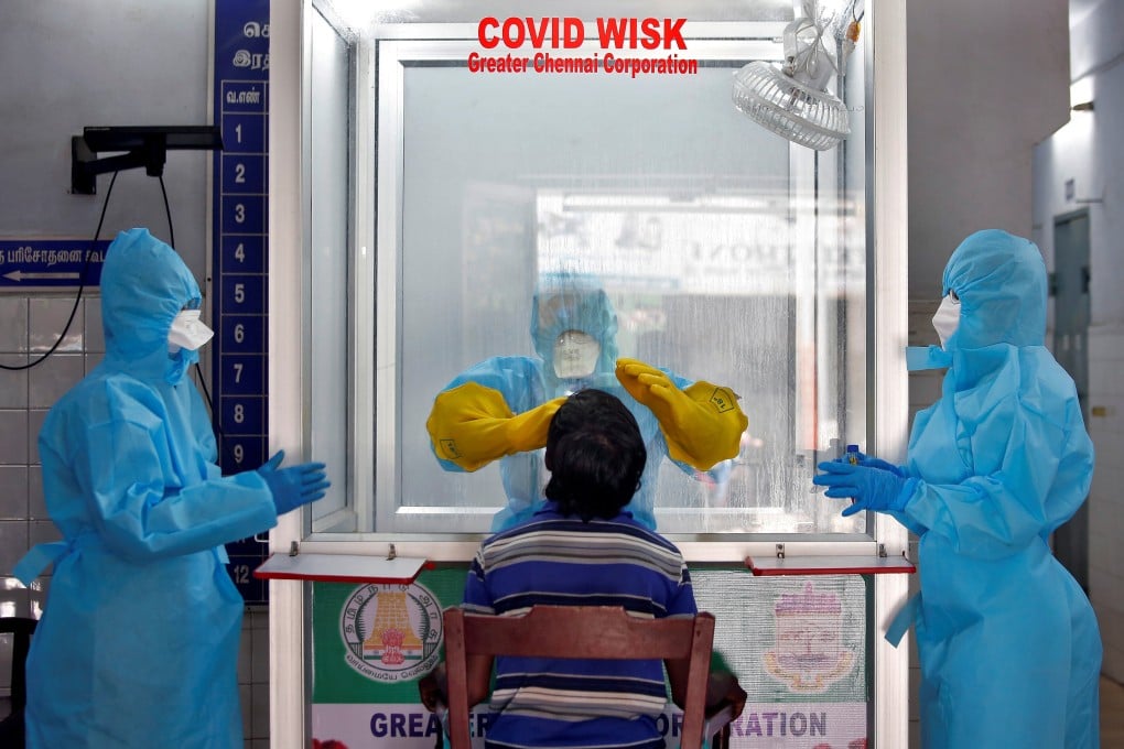 A doctor in a protective chamber takes a swab from a man to test for coronavirus disease (Covid-19) at a government-run hospital in Chennai, India. Some 3,200 Hongkongers are believed stranded in the country. Photo: Reuters