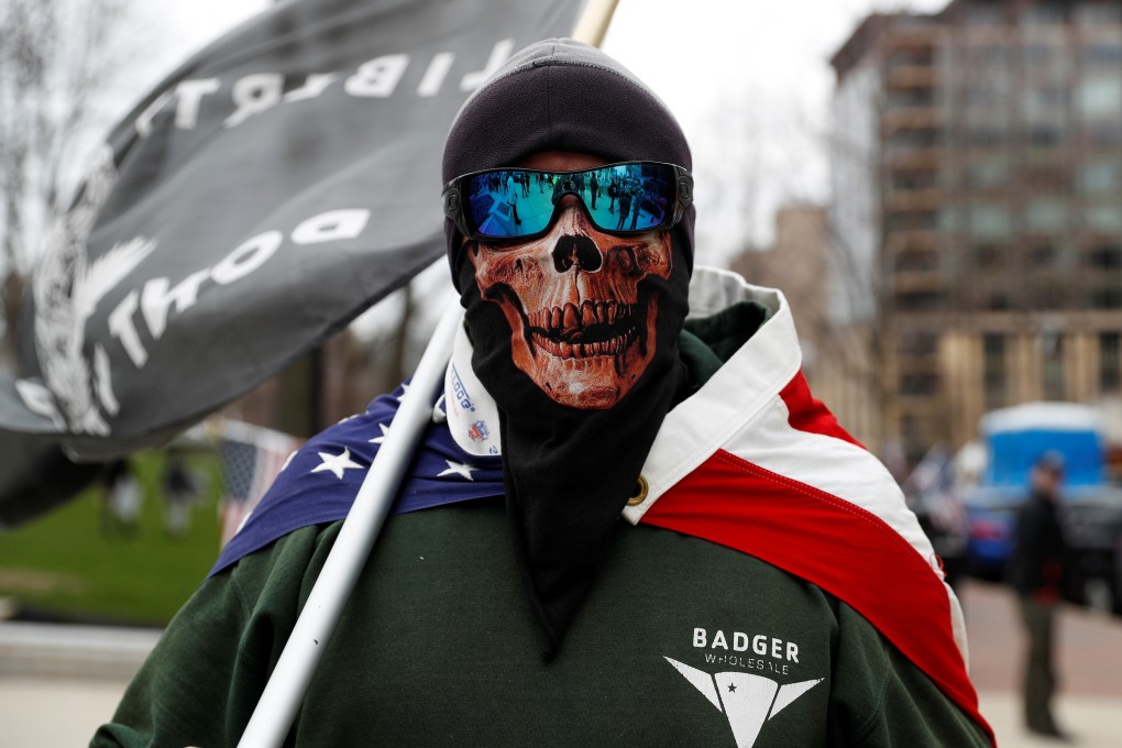 A man wearing a mask poses as demonstrators in Madison protest the extension of Wisconsin’s emergency Safer at Home order on Friday. Photo: Reuters