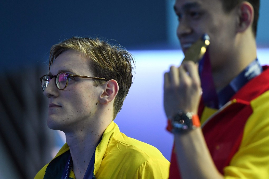 Mack Horton (left) stares straight ahead as China’s Sun Yang celebrates 400m gold at the world championships in Gwangju, South Korea. Photo: AP