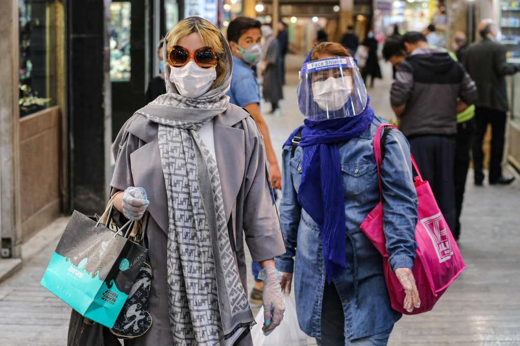 Shoppers clad in protective gear walk through the Tajrish Bazaar in Iran's capital Tehran. Photo: AFP