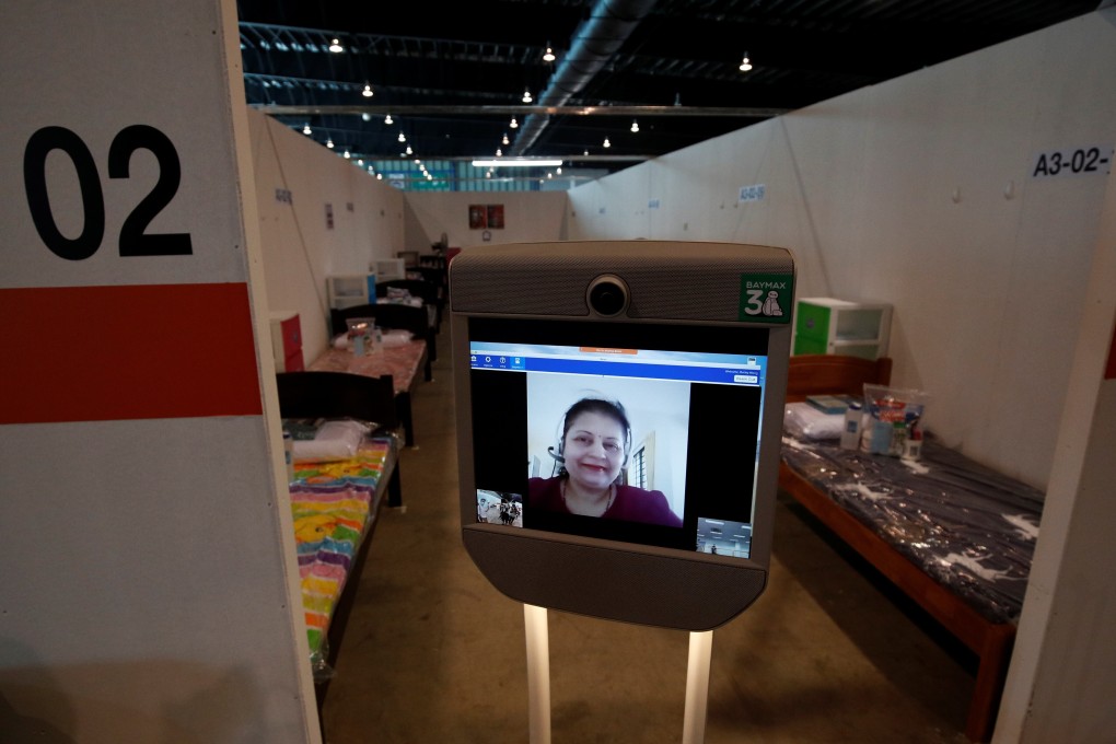 A volunteer who provides translation services for migrant workers is pictured on the screen of a ‘telepresence’ robot at Changi Exhibition Centre. Photo: Reuters