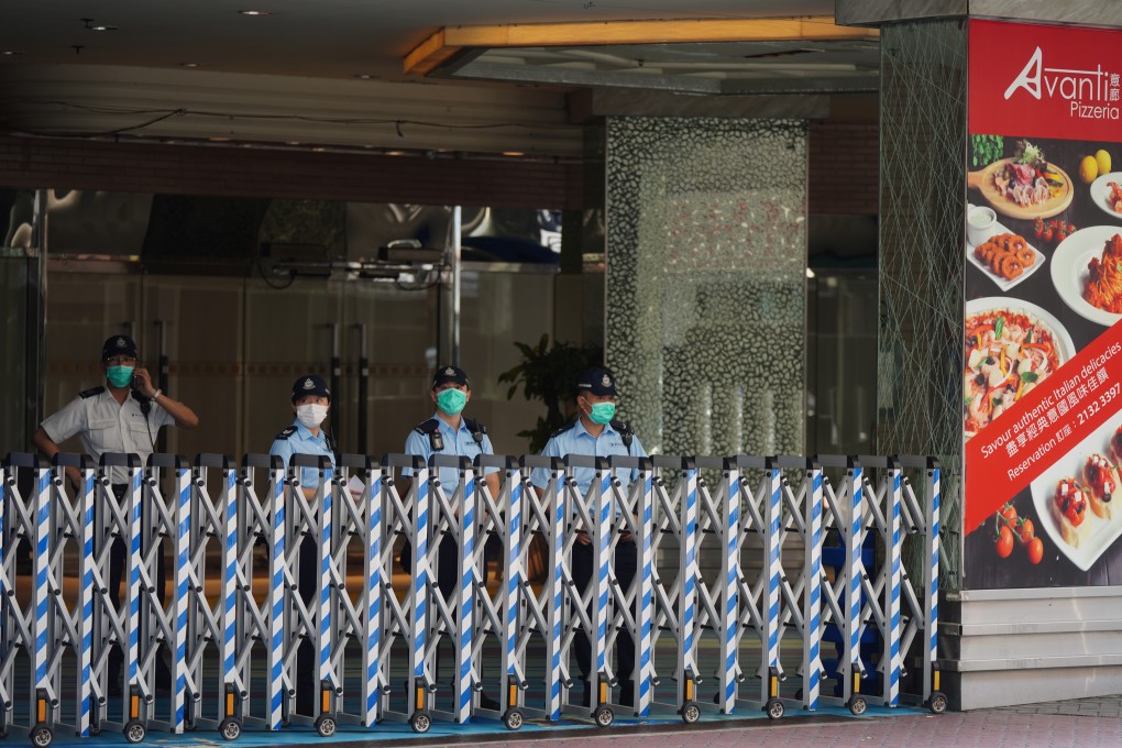 Police officers at the Regal Oriental Hotel in Kowloon City on April 21. The hotel has been turned into a temporary overnight holding centre for asymptomatic returnees landing in the afternoon or evening. Photo: Sam Tsang