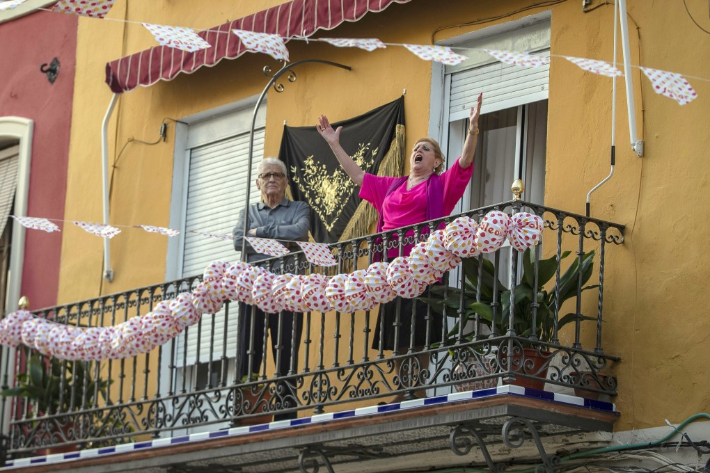 Aa woman sings on her decorated balcony during the annual traditional April Fair in Seville, Spain. Photo: AP
