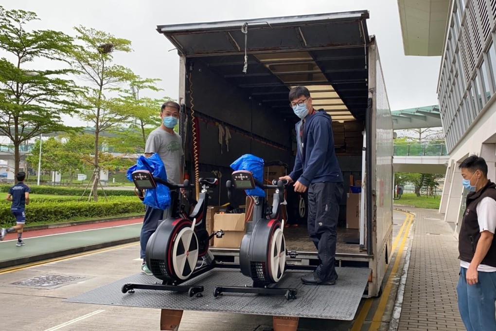 Hong Kong Sports Institute ‘Ergo Panda’ coaches load a truck with exercise bikes to deliver to rowers stuck at home. Photo: HKCRA