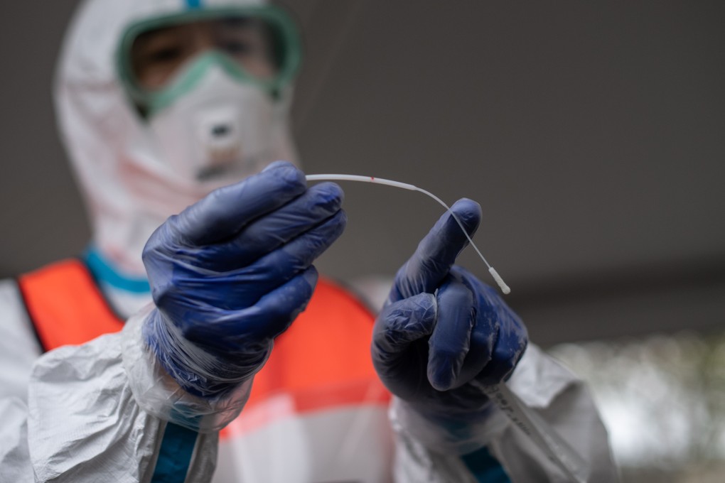 A doctor displays a swab used to test patients at a drive-through Covid-19 testing centre in Kanagawa prefecture, southwest of Tokyo, on Monday. Photo: AFP