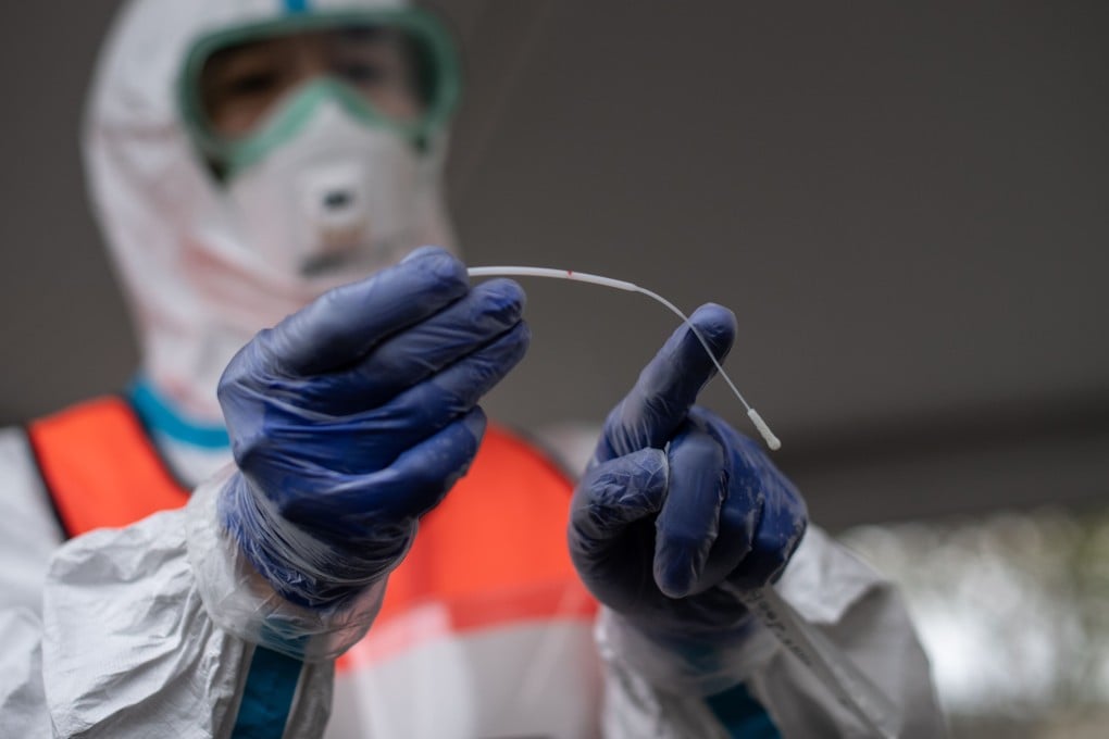 A doctor displays a swab used to test patients at a drive-through Covid-19 testing centre in Kanagawa prefecture, southwest of Tokyo, on Monday. Photo: AFP