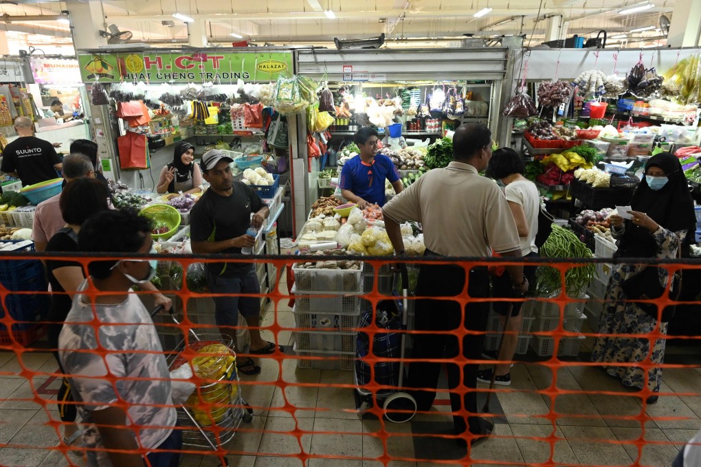 People shop for food items at a market in Singapore. Many of the city state’s home food businesses are feeling the pinch after strict coronavirus containment measures were implemented. Photo: AFP