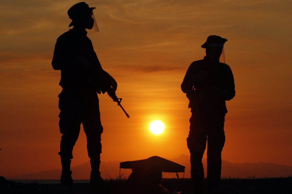 Filipino soldiers wearing face masks to guard against the coronavirus on patrol in the Philippines. Photo: EPA