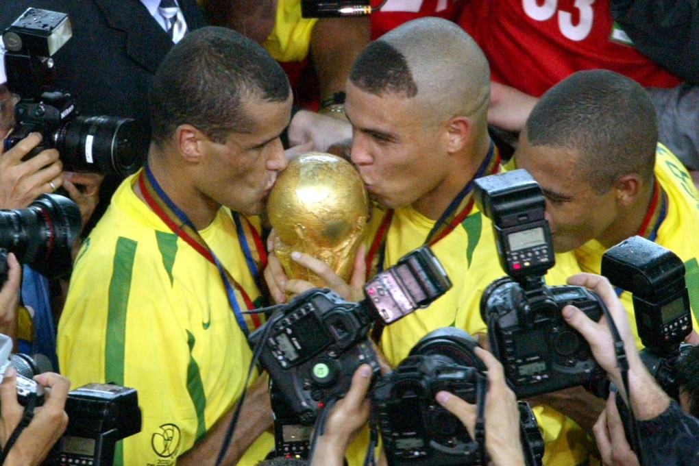 Brazil's Ronaldo (C) and Rivaldo (L) kiss the Fifa World Cup trophy in 2002. Coach Luiz Felipe Scolari gave his players passages from the Art of War during the tournament. Photo: Reuters