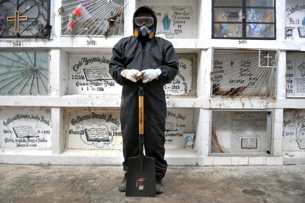 A worker at the Angel Maria Canals municipal cemetery in Guayaquil, Ecuador. Photo: AFP
