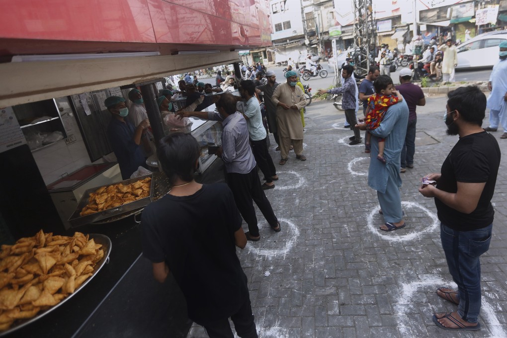 Shoppers maintain social distance in Lahore, Pakistan. Thousands of Hong Kong residents are stranded in the country because of the lockdown. Photo: AP