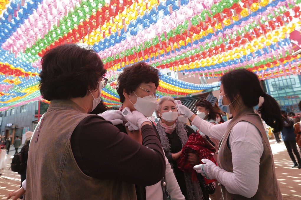 Devotees receive temperature check as they arrive to celebrate Buddha’s birthday at the Chogyesa temple in Seoul. Photo: AP