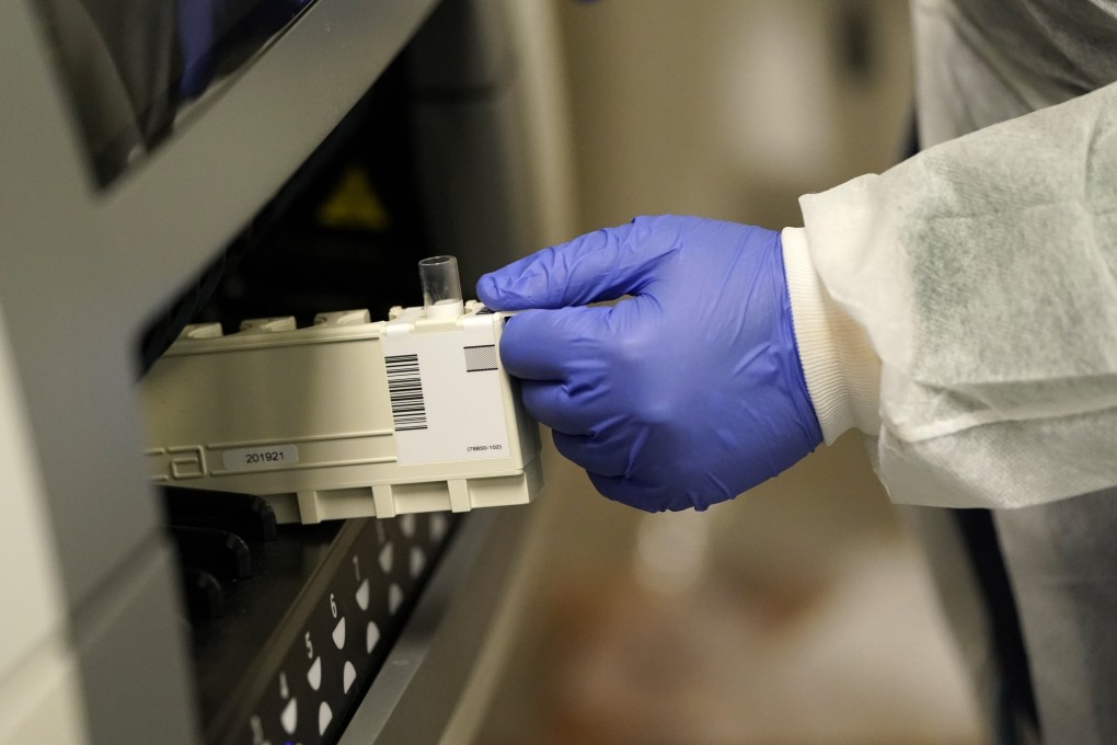 A medical technologist at Principle Health Systems and SynerGene Laboratory, loads a sample for COVID-19 antibody testing. Photo: AP