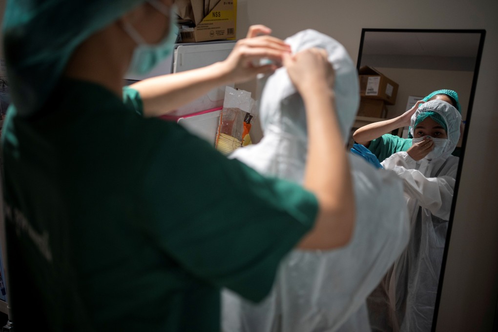 A nurse at a Bangkok hospital receives help from a colleague putting on her protective suit before attending to Covid-19 patients on April 22. Women are not just taking care of their own families, but are also active on the Covid-19 front lines. Worldwide, 70 per cent of health and social service providers are women. Photo: Reuters