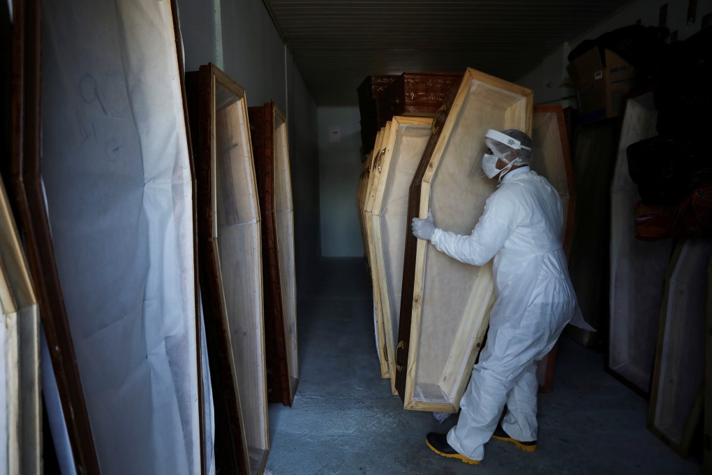 A worker prepares coffins in Manaus, Brazil. Photo: Reuters
