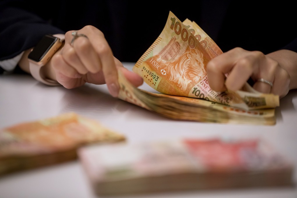 An employee counting HK$1,000 banknotes at the Hang Seng Bank headquarters in Hong Kong on Tuesday, April 16, 2019. Photo: Bloomberg
