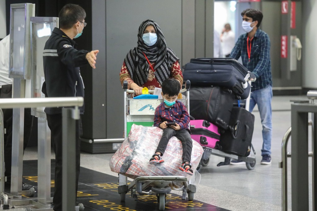 Hong Kong residents arrive back home from Pakistan on Thursday. Photo: K. Y. Cheng