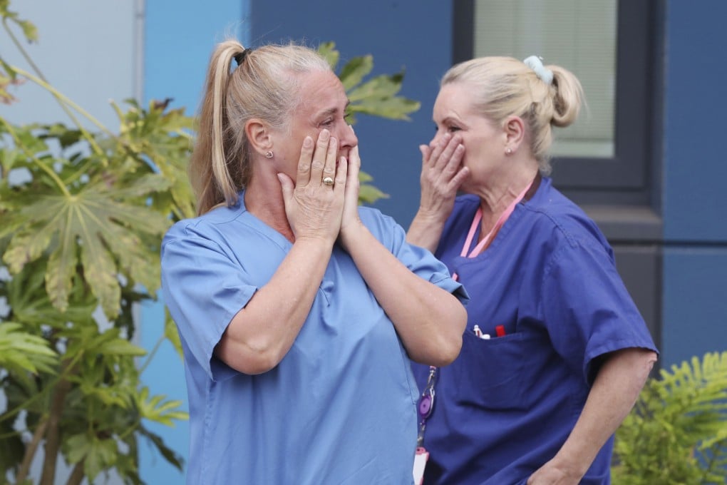 Staff at Salford Royal Hospital in Manchester during a minute's silence for NHS staff and key workers who have died during the coronavirus outbreak. Photo: AP