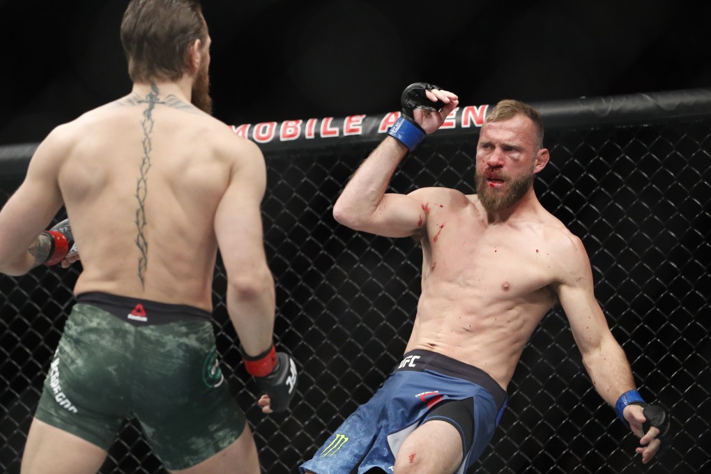 Donald “Cowboy” Cerrone falls after being kicked in the head by Conor McGregor at UFC 246. Photo: AP