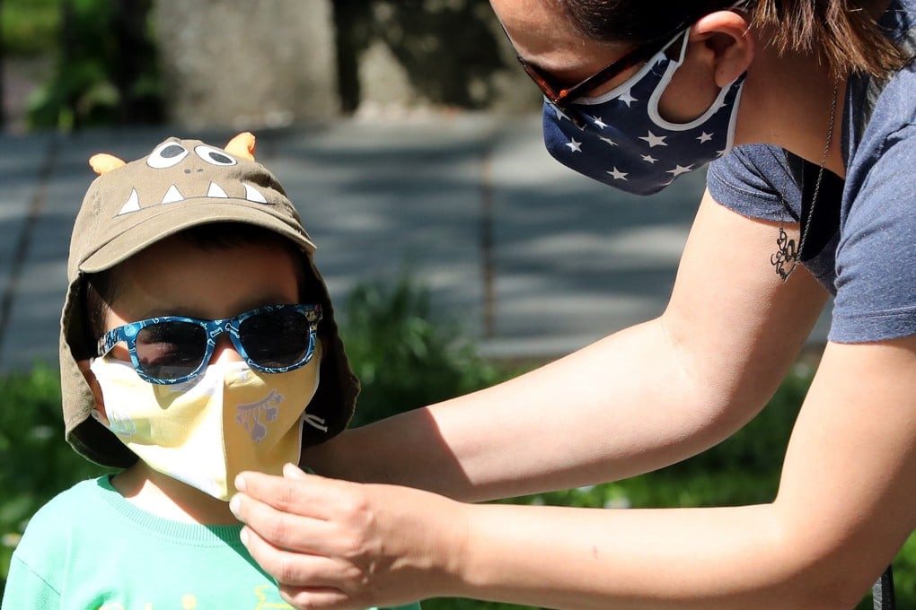 A mother adjusts her son’s face mask on Saturday, amid the coronavirus pandemic in Sarajevo, Bosnia and Herzegovina. Photo: EPA-EFE