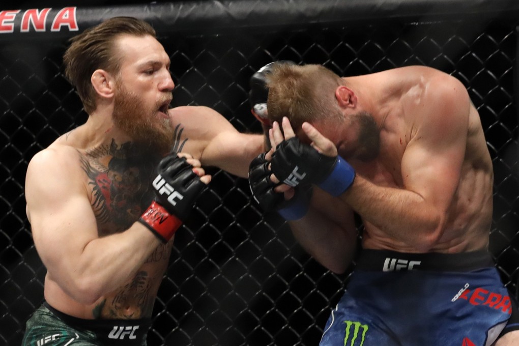 Conor McGregor punches Donald Cerrone in their welterweight bout at UFC 246. Photo: AFP