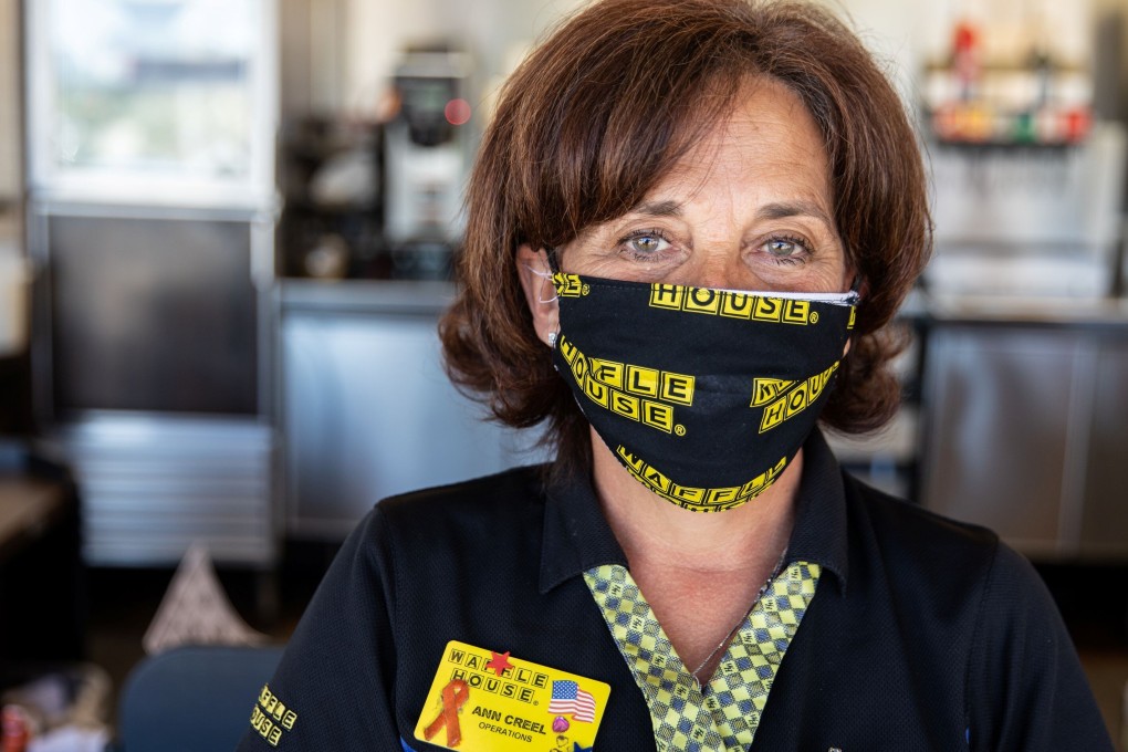 A US restaurant employee wears a cloth face mask. The use of cloth face masks, which can be washed and reused, is being encouraged by governments around the world – but how do you keep them clean? Photo: Reuters