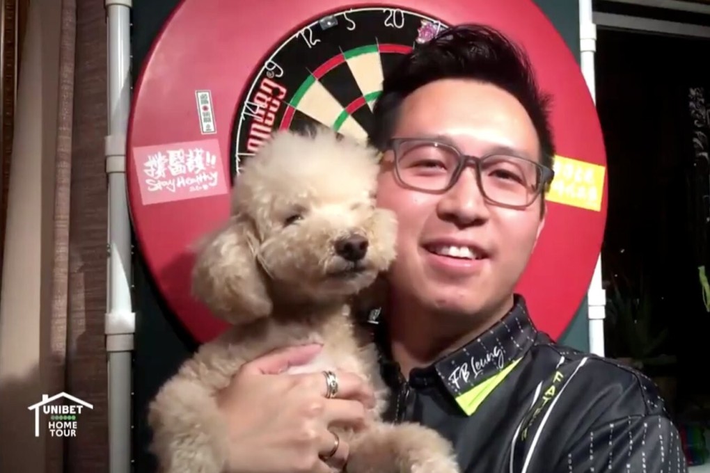 Kevin Leung Kai-fan with his dog Bauble after his match against Chris Dobey. Photo: PDC