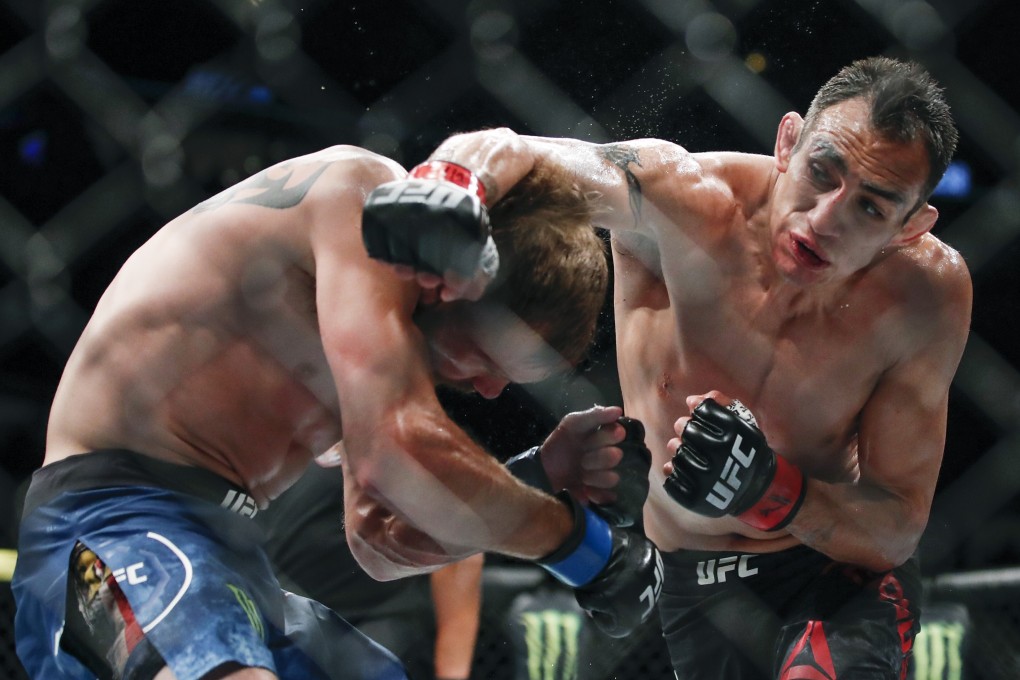 Tony Ferguson punches Donald Cerrone during their lightweight bout at UFC 238 in Chicago. Photo: AP