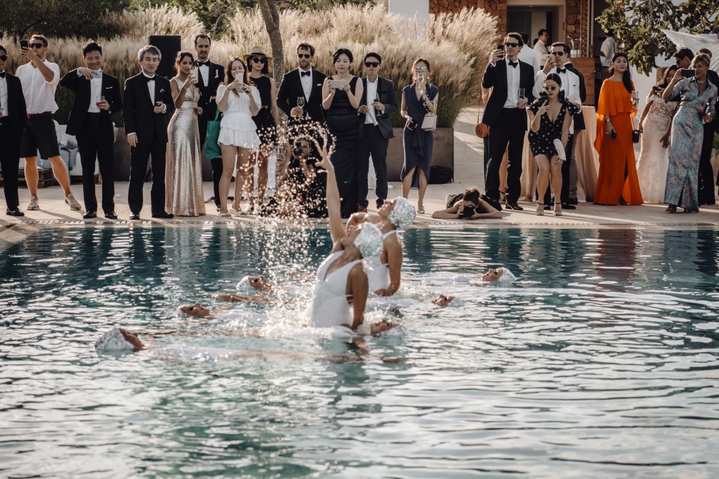 A couple who met in the lift of the Mandarin Oriental Hong Kong hotel married in a lavish wedding in Ibiza, Spain – complete with synchronised swimmers, celebrity DJs and waiters who broke out into song.