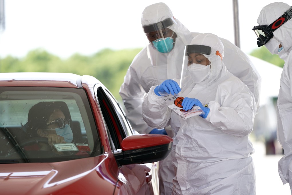 A nurse prepares to administer a test at a Covid-19 drive-through testing site in Houston, Texas. Photo: AP