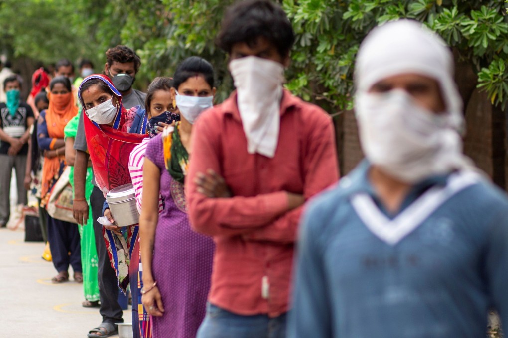 Indians wait to receive free food in New Delhi during an extended nationwide lockdown. Photo: Reuters