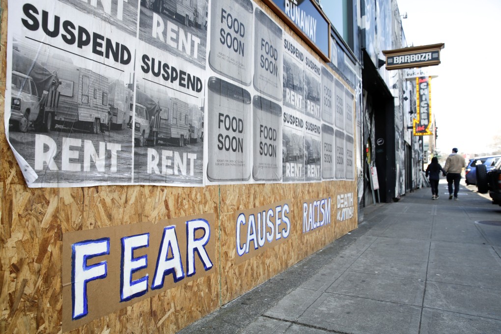 A sign that reads “Fear causes racism” is seen on a boarded-up shopfront in Seattle, Washington, in March. Photo: Reuters