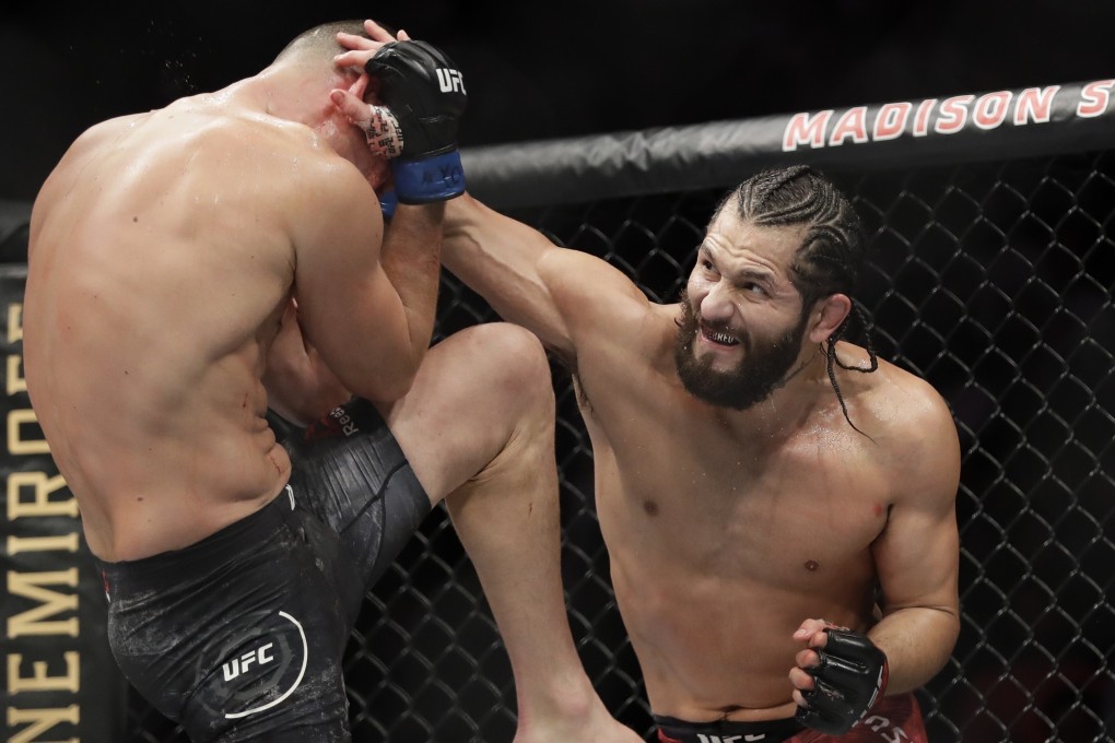 Jorge Masvidal punches Nate Diaz during their BMF bout at UFC 244 in 2019. Photo: AP