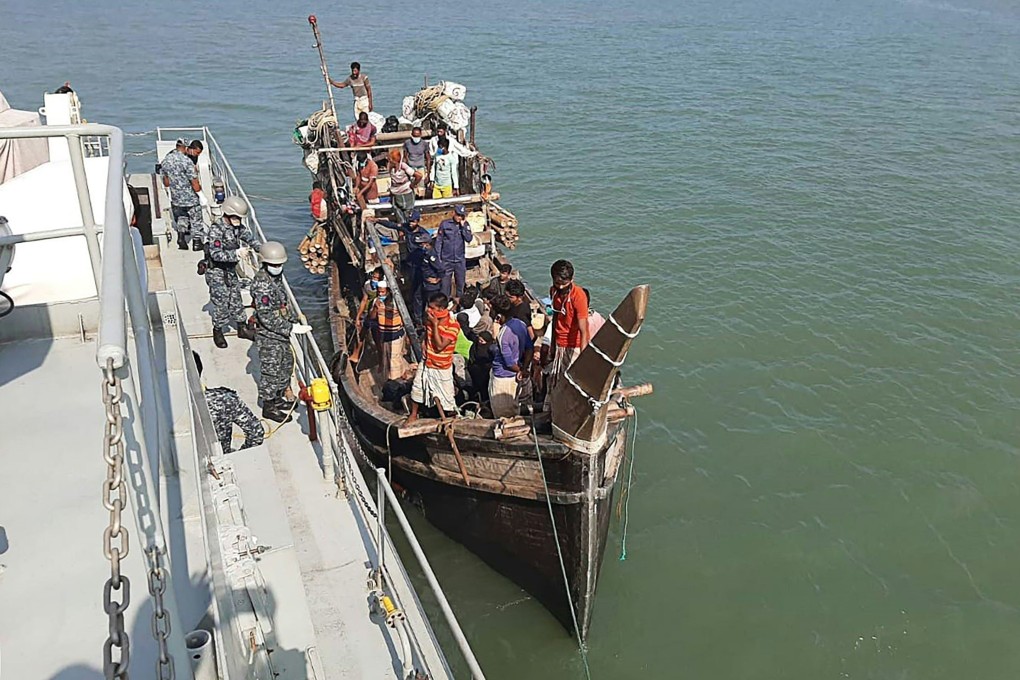 Rohingya refugees stranded at sea are seen on a boat near the coast of Cox's Bazar. Dozens of Rohingya Muslims believed to have been on two boats were stranded at sea for weeks as they tried to reach Malaysia. Photo: AFP