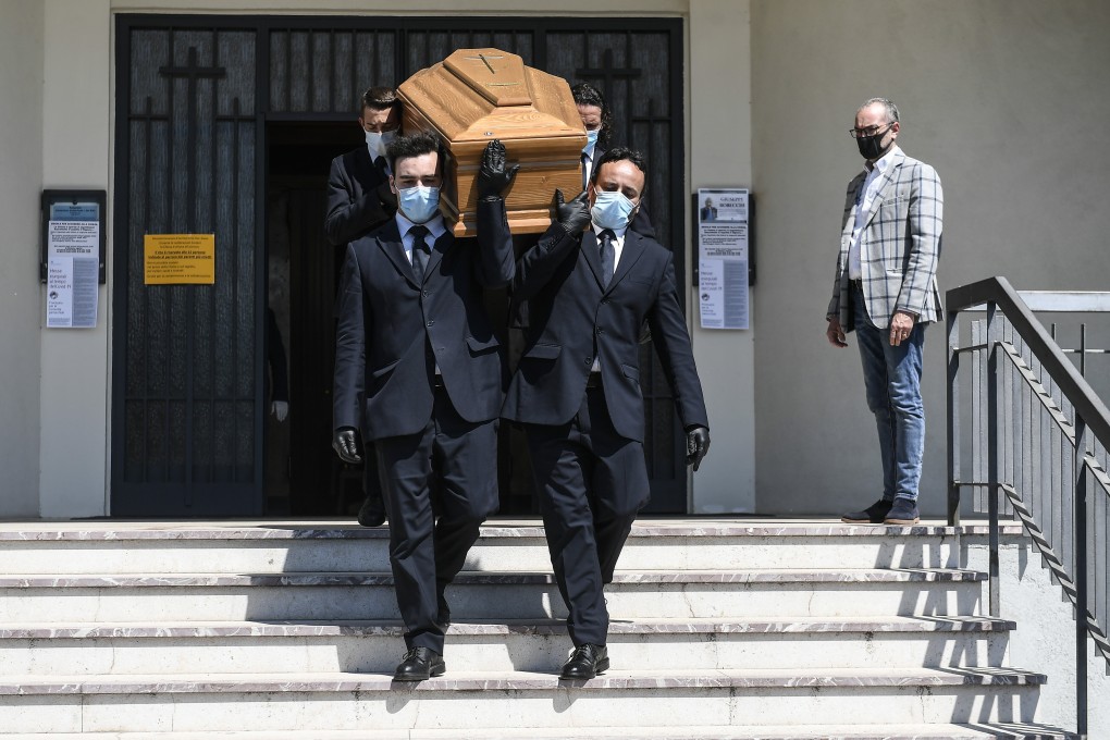 Pallbearers carry the coffin of a coronavirus victim out of a church in Brescia, Italy on Monday. Photo: dpa