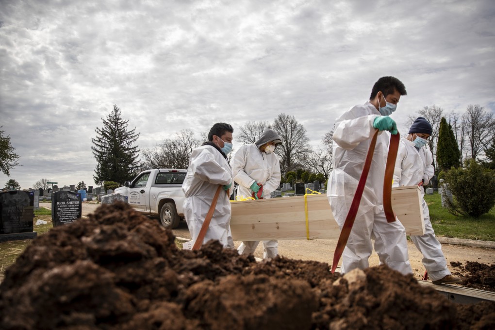 Gravediggers carry the casket of someone presumed to have died from Covid-19 at a cemetery in the Staten Island borough of New York. Photo: AP