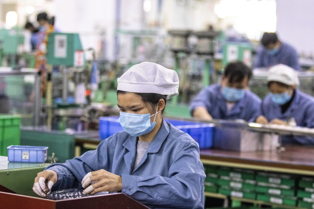 Workers on the floor of Galanz factory in Foshan, China, on February 18. Industrial production saw a V-shaped recovery after lockdown restrictions were eased. Photo: EPA-EFE