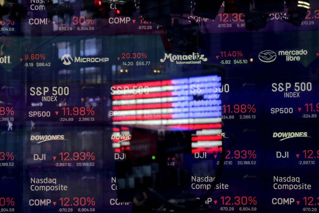 The United States flag is reflected in the window of the Nasdaq studio at Times Square in New York on March 16, 2020. Photo: AP
