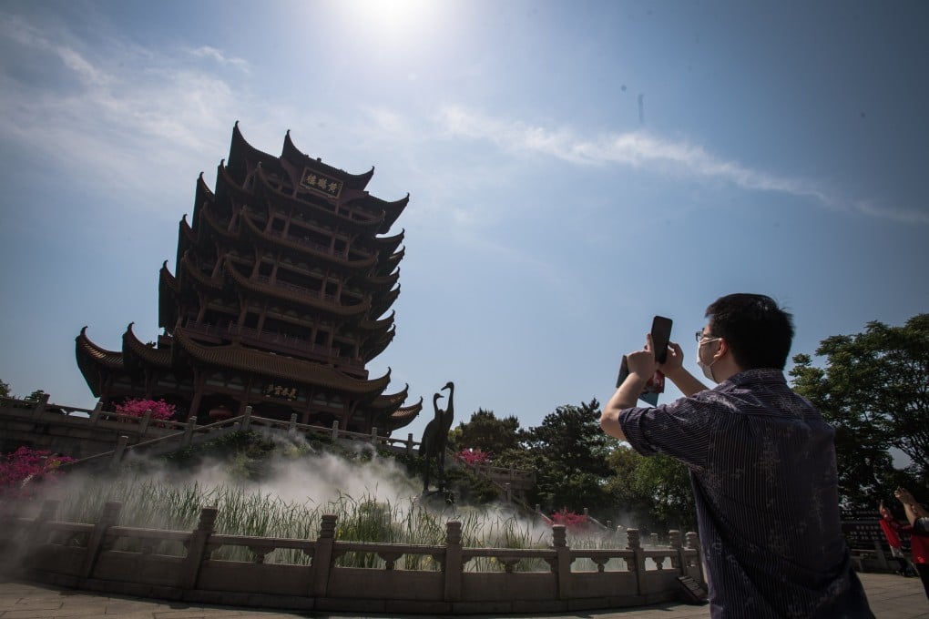 A tourist photographs the Yellow Crane Tower, one of the most popular tourist attractions in Wuhan, in central China’s Hubei Province, on April 29. Photo: Xinhua