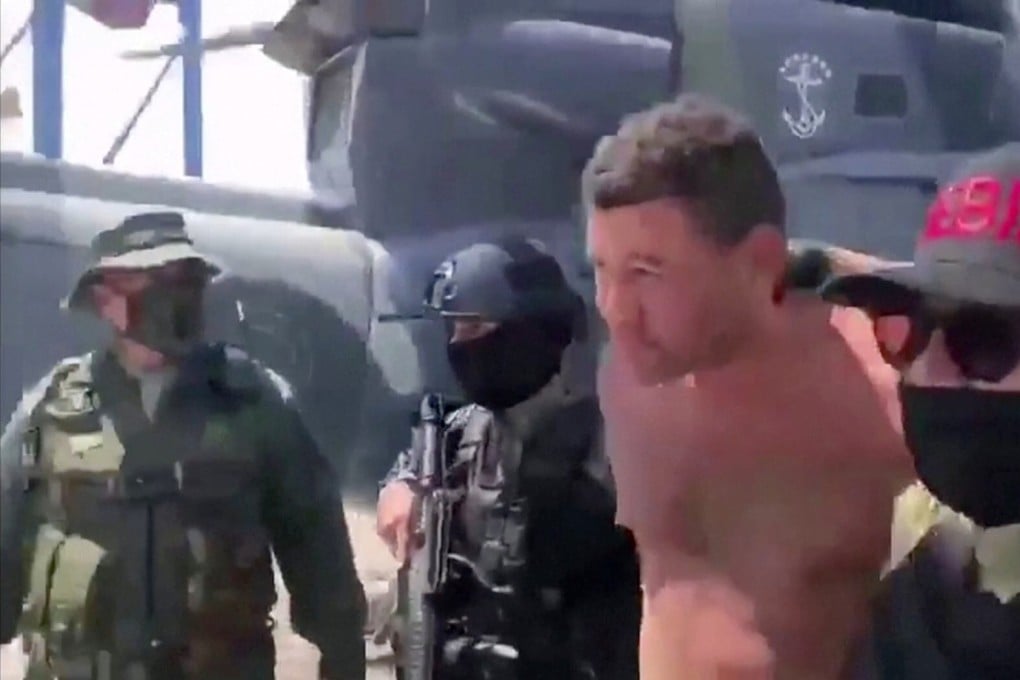 Venezuelan soldiers in balaclavas move a suspect from a helicopter after what Venezuelan authorities described as a ‘mercenary incursion’ Photo: Venezuelan government handout via Reuters