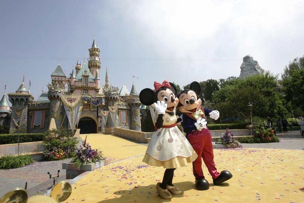 Mickey and Minnie Mouse in front of the Sleeping Beauty Castle during the 50th anniversary of the opening of Disneyland in Anaheim, California on 17 July 2005. Photo: AFP